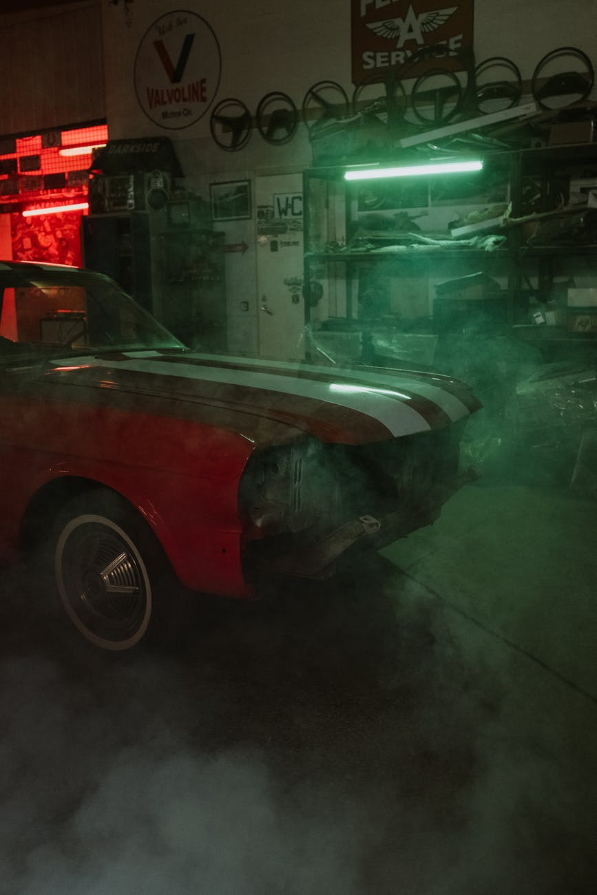 red car parked in front of store