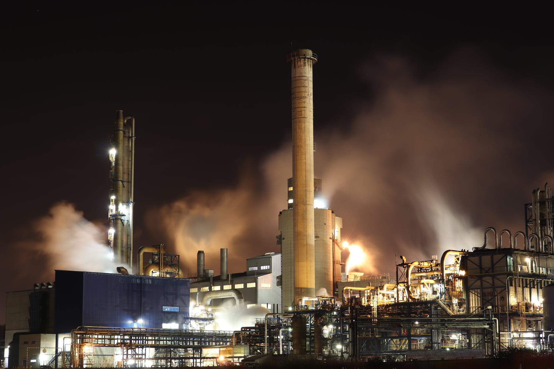 brown and white factory building during night time