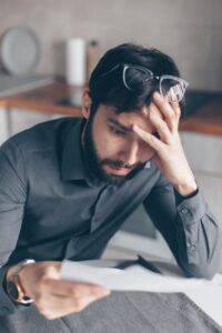 man in blue dress shirt wearing black framed eyeglasses