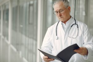 contemplative doctor in uniform reading clinical records