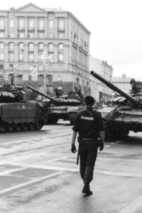 policeman walking near tanks