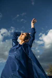 low angle view of woman with hands raised