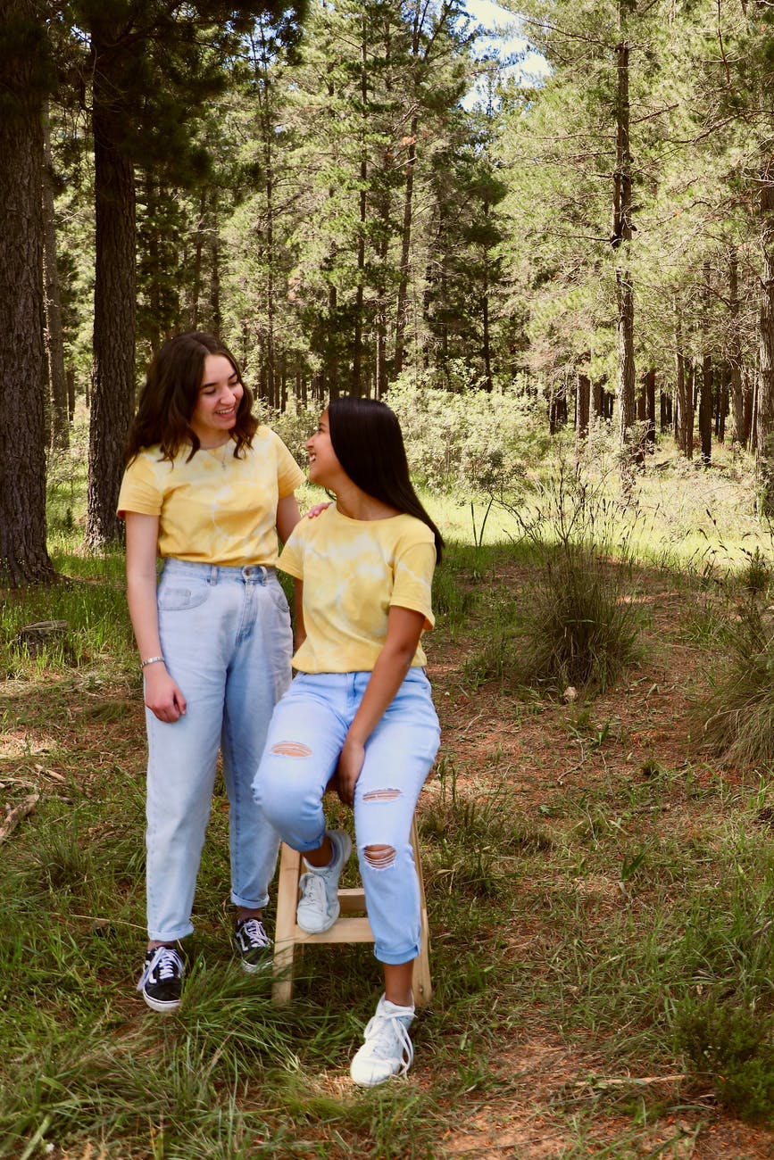 women in the forest wearing matching outfits