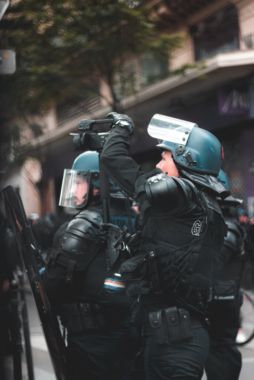 unrecognizable police officer in protective helmet on street