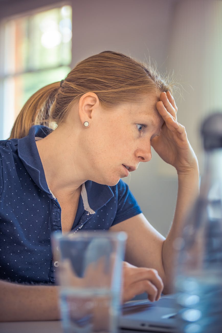 woman sitting in front of the laptop computer in shallow photo