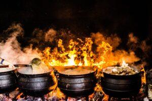 time lapse photography of four black metal cooking wares