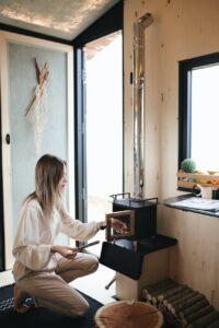 woman lighting a small fireplace