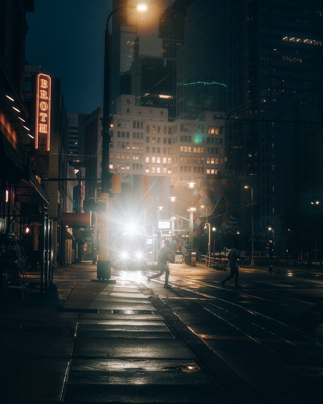 people crossing the street at night