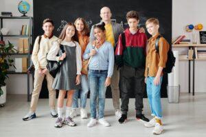 smiling students with their teacher