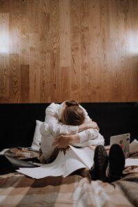 tired woman sitting on the bed