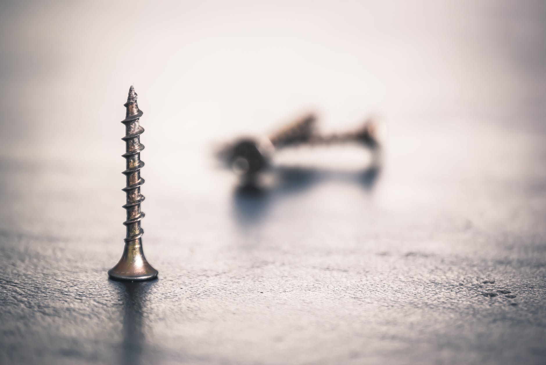 shallow focus photo of screw