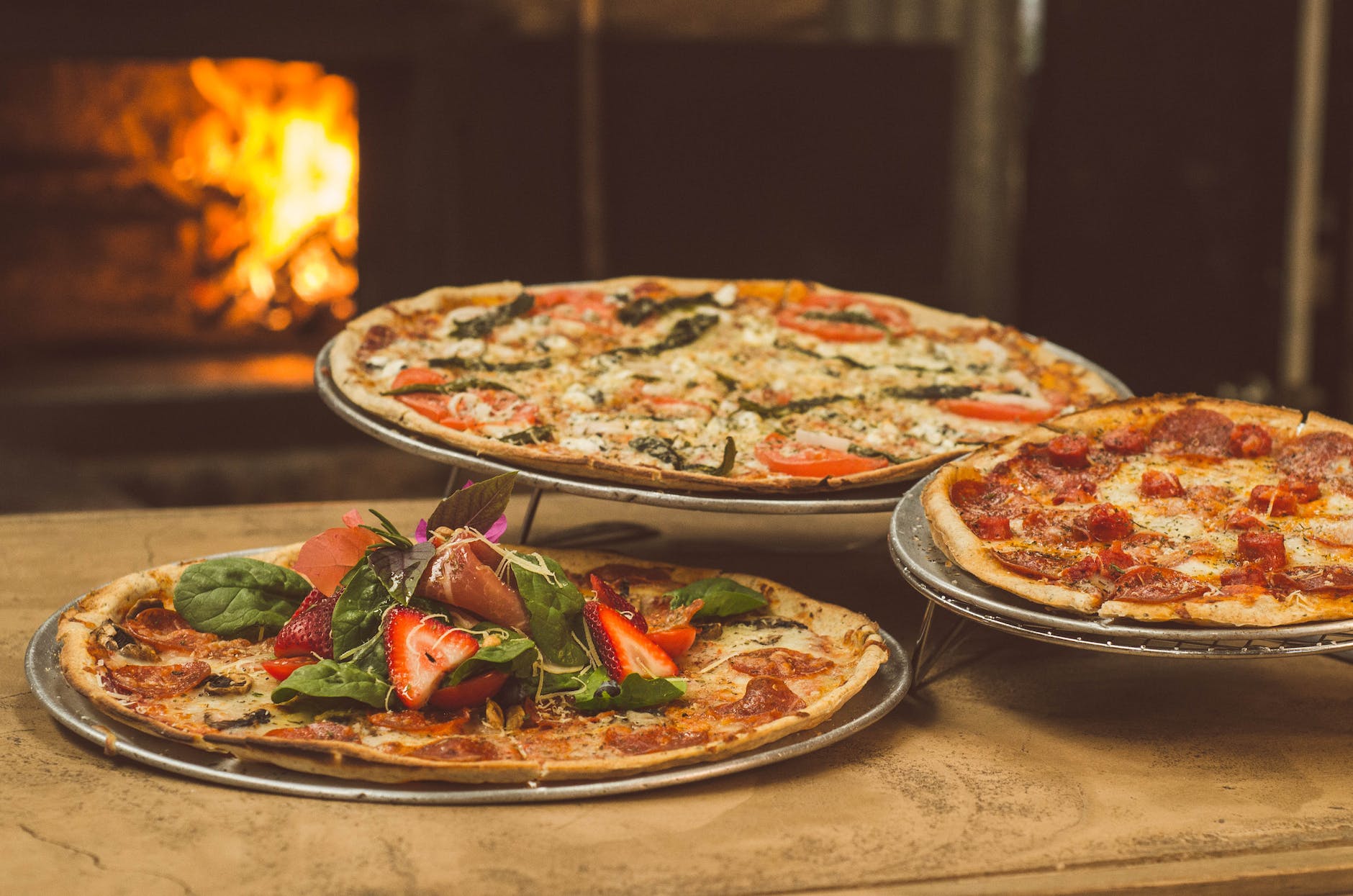 shallow focus photography of several pizzas