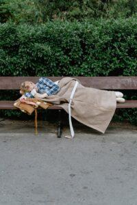 a woman sleeping on the bench