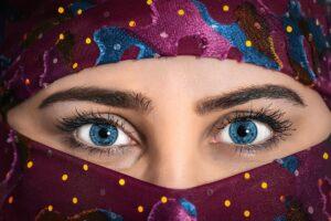 woman with blue eyes wearing purple hijab scarf