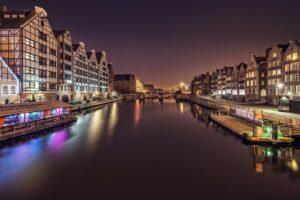 canal between house facades in night city