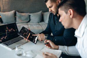 man in black long sleeve shirt holding black tablet computer