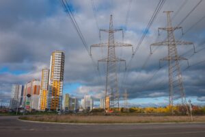 electrical posts and power lines under cloudy sky