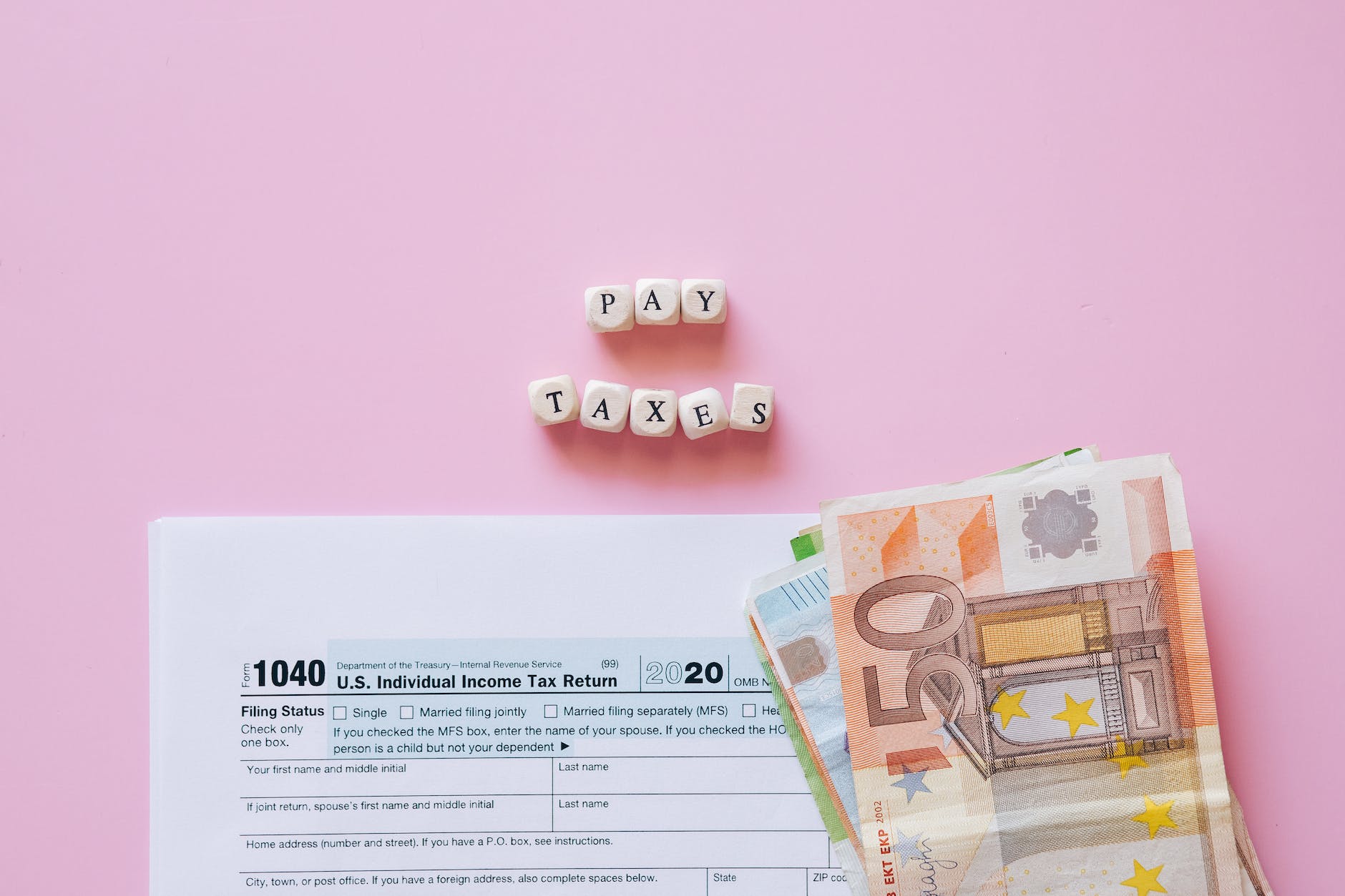 money on the white form beside the letter blocks