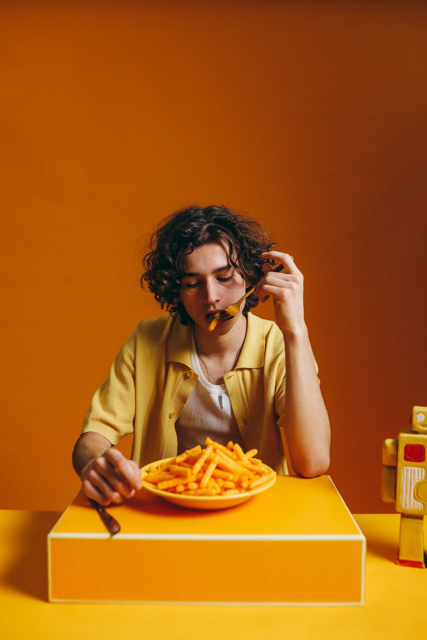 a young man eating french fries