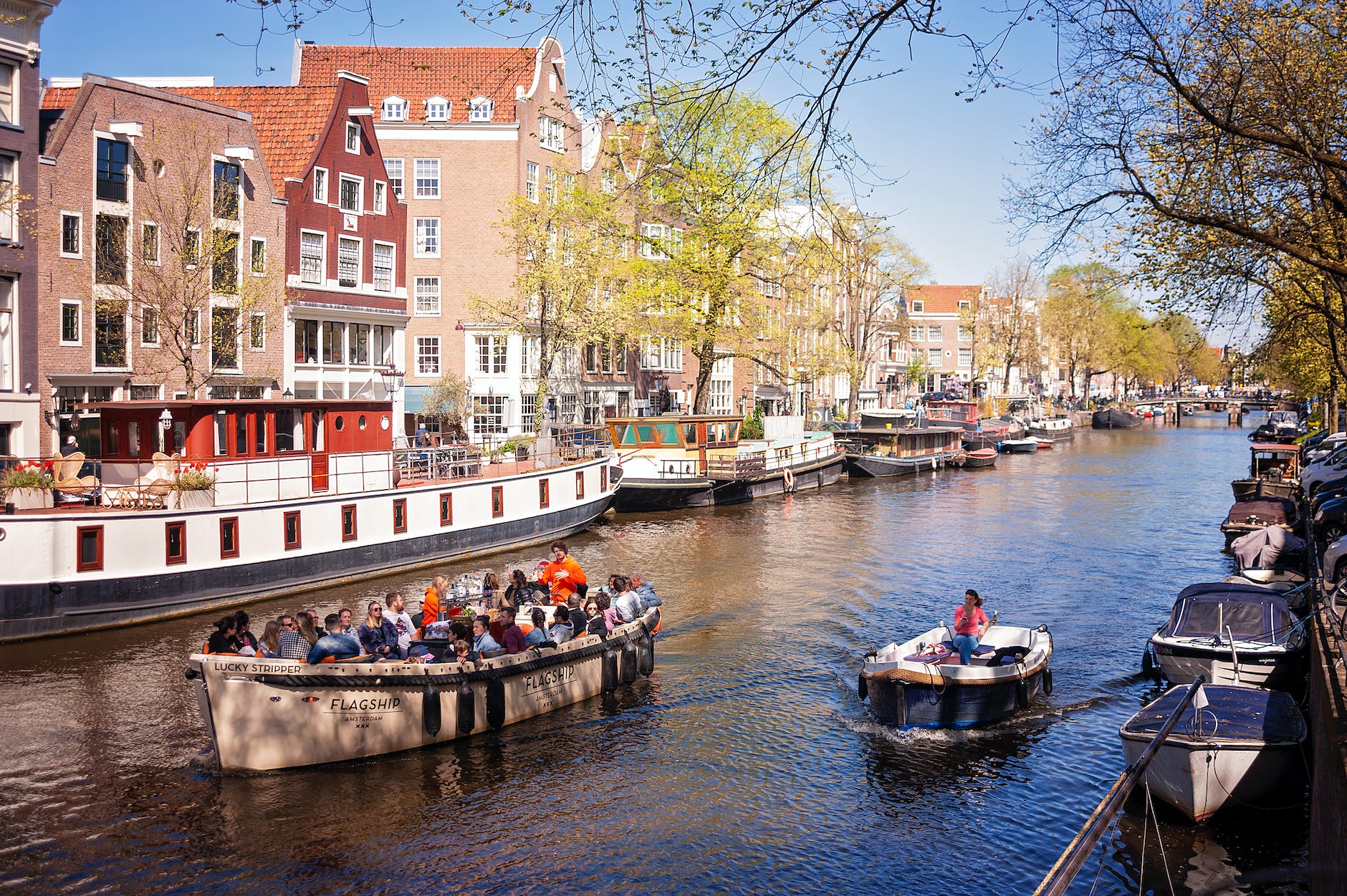 people boating on canal in amsterdam