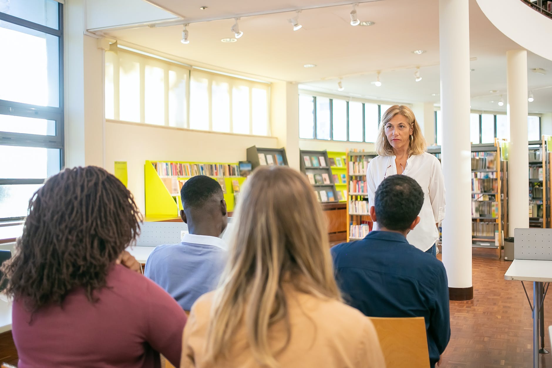 multiethnic students listening lecturer in university