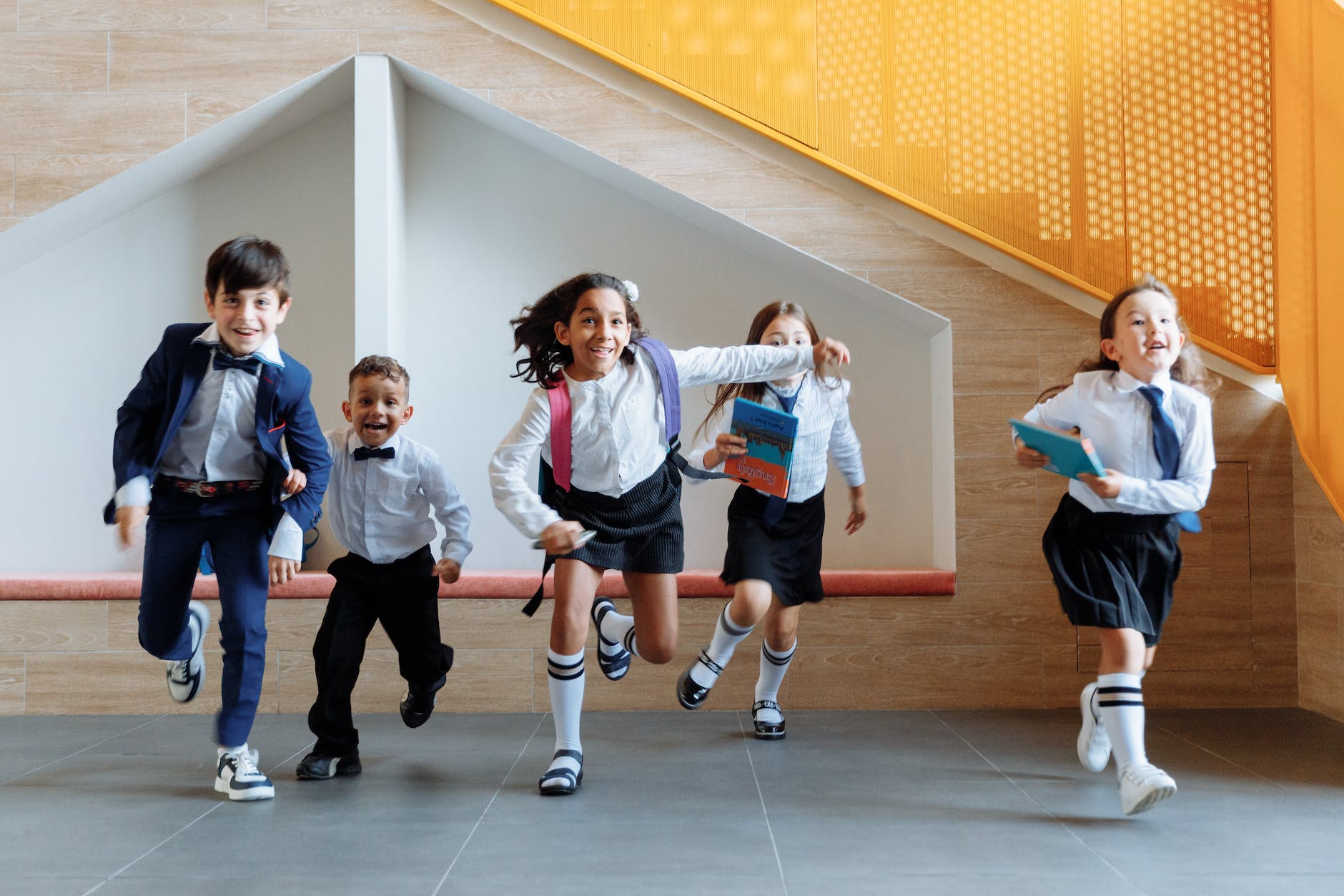 students running together inside the school