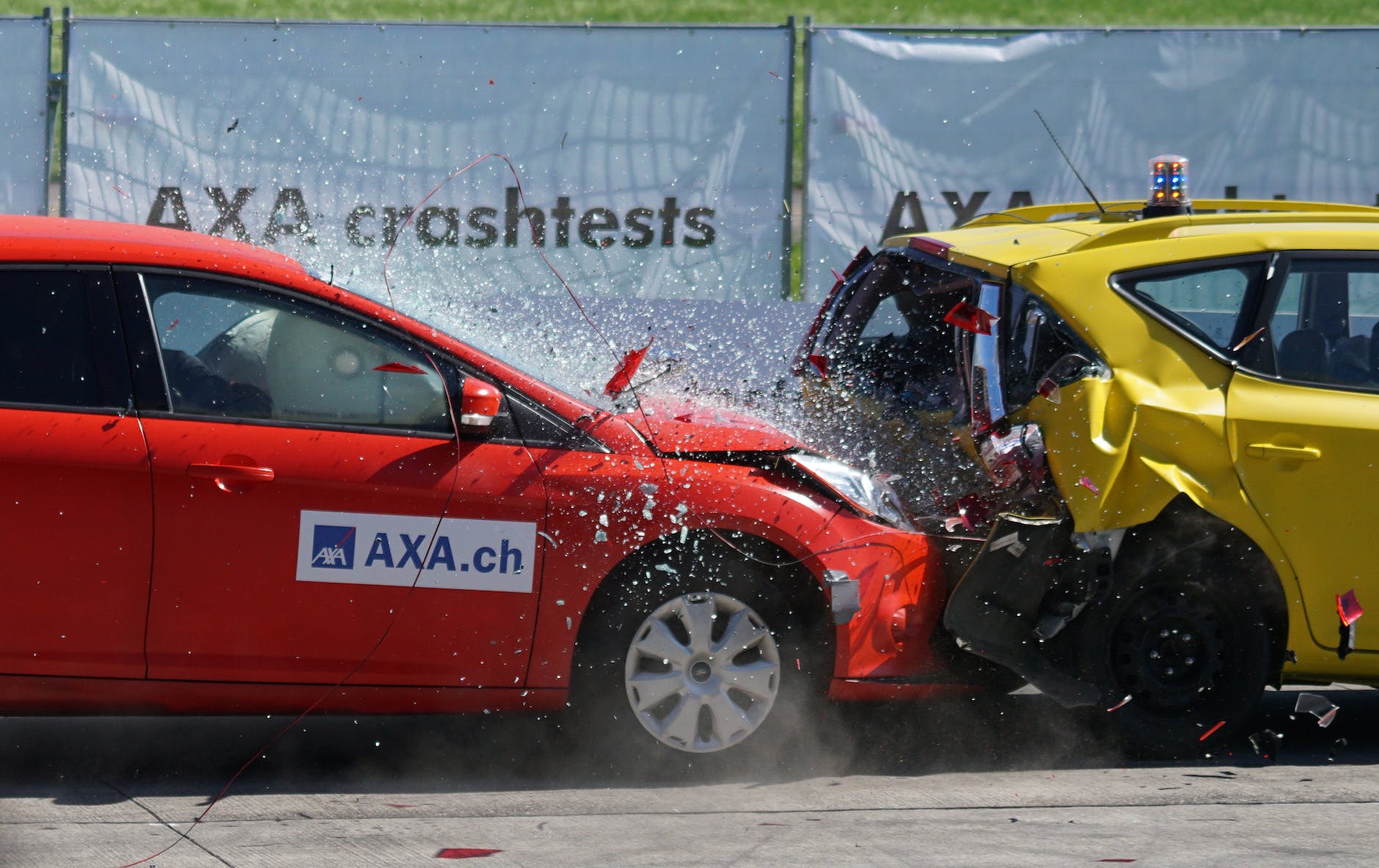 red and yellow hatchback axa crash tests