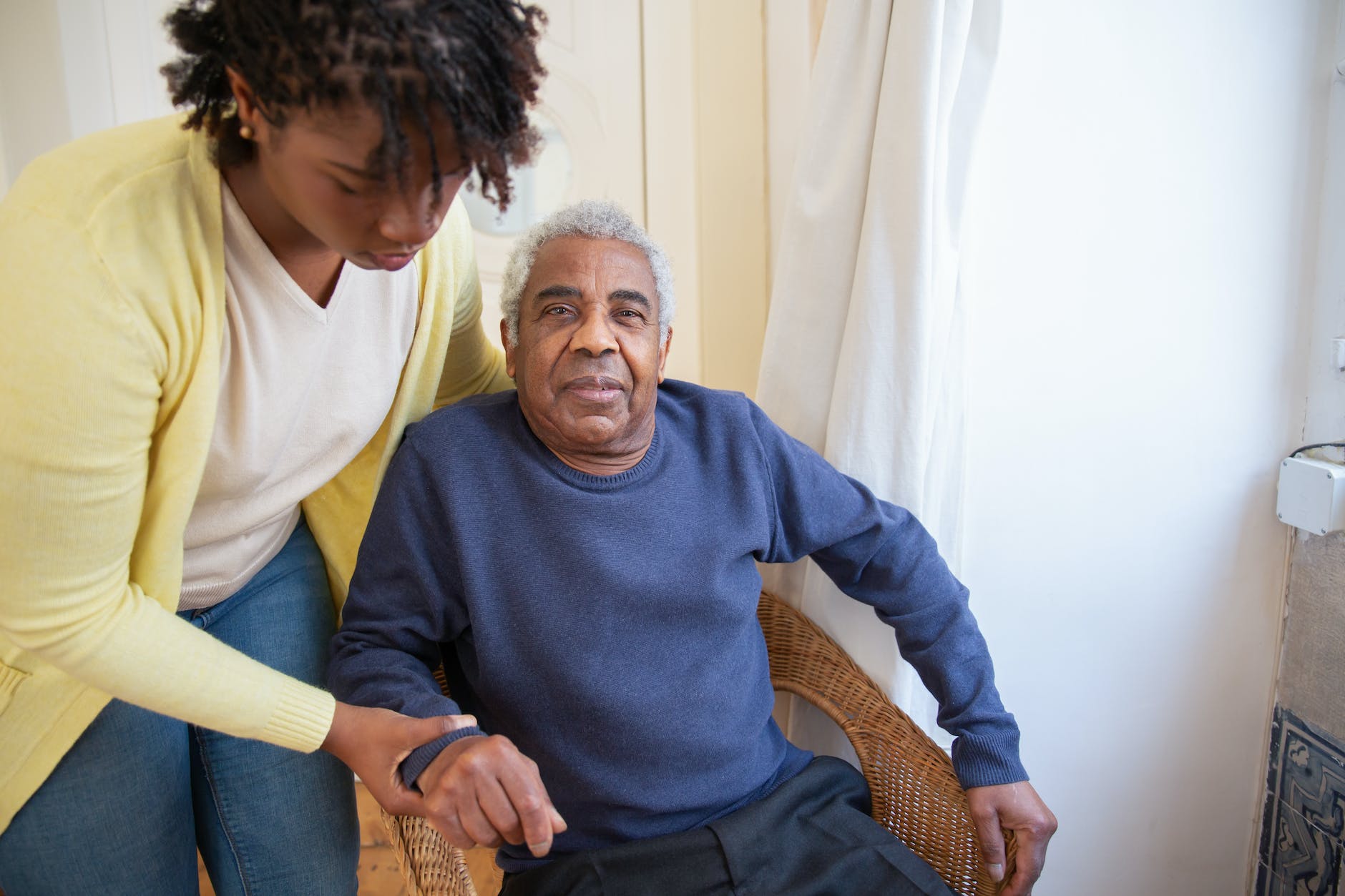 woman assisting elderly man