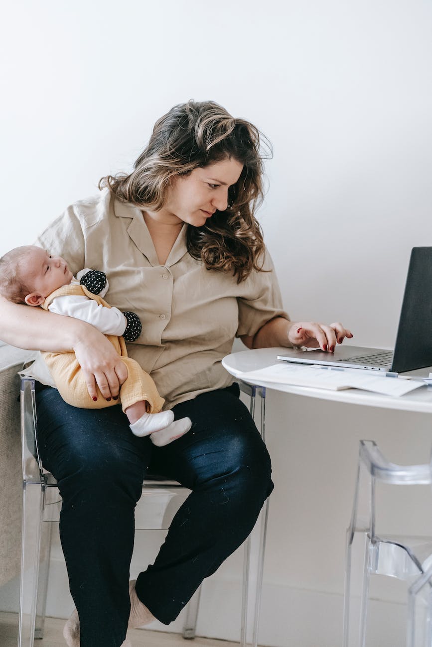 mother with baby using laptop