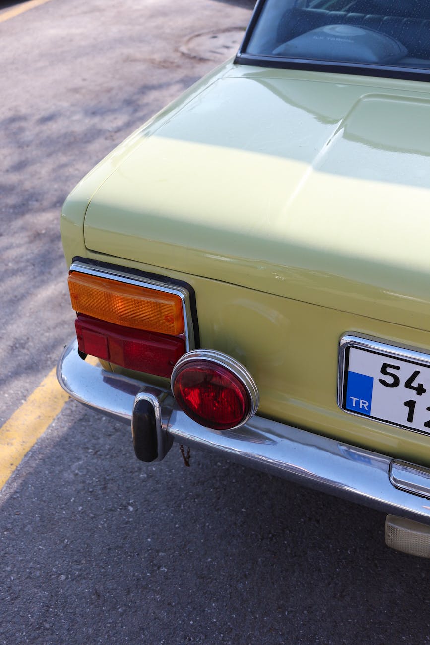 retro car on asphalt road in town