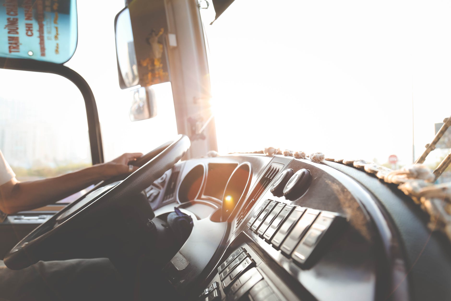 person hand on steering wheel