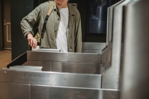 crop man using card to enter city subway gate